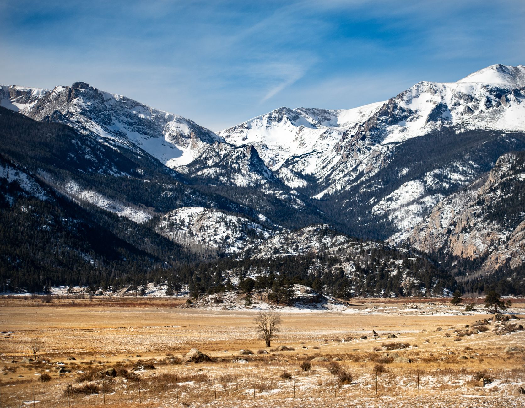 Snow-capped Rocky Mountain peaks above a Colorado valley